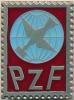 Metalowa odznaka w kształcie znaczka pocztowego z literami PZF.